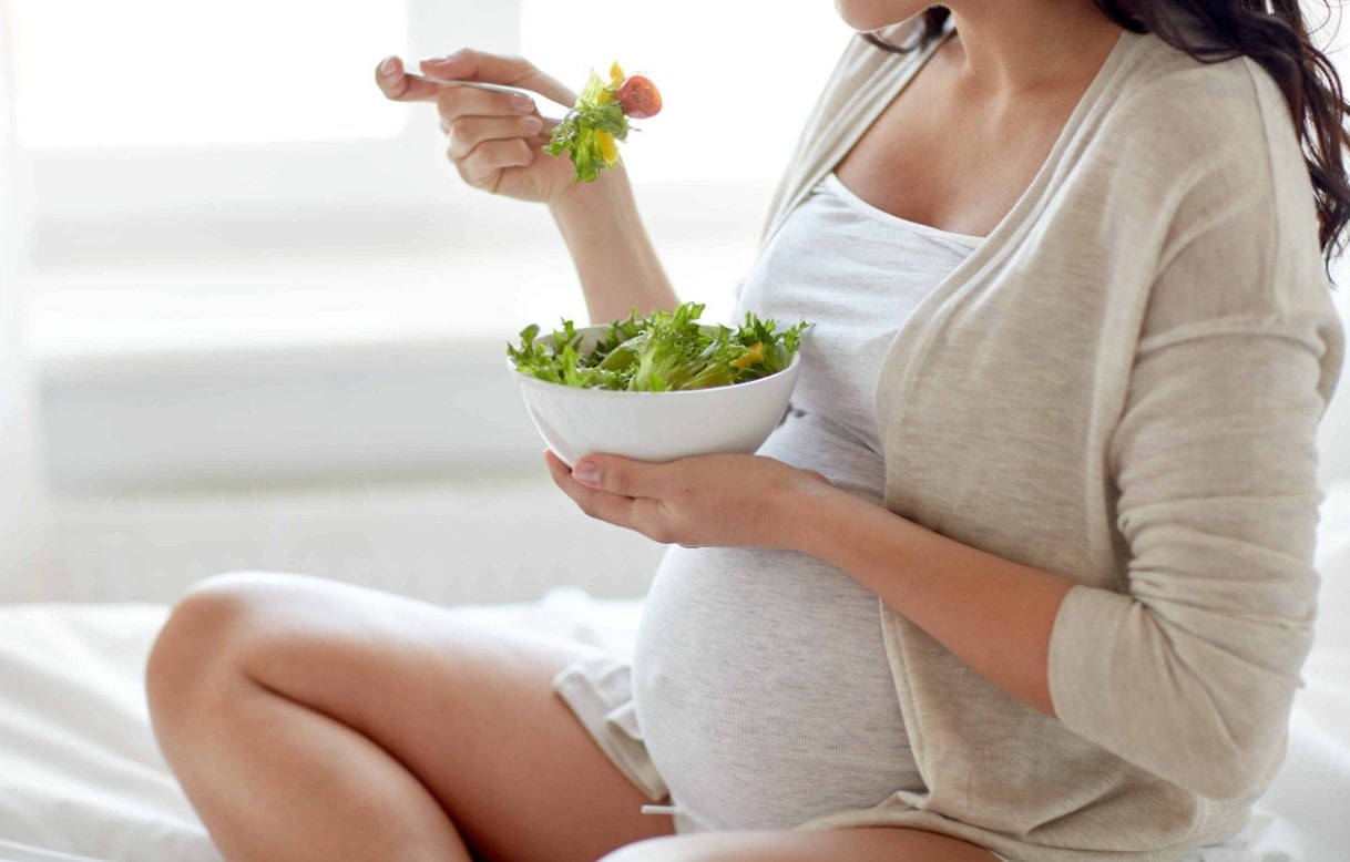임산부 건강한 식습관 관련 앉아서 샐러드를 먹고 있는 임산부 모습